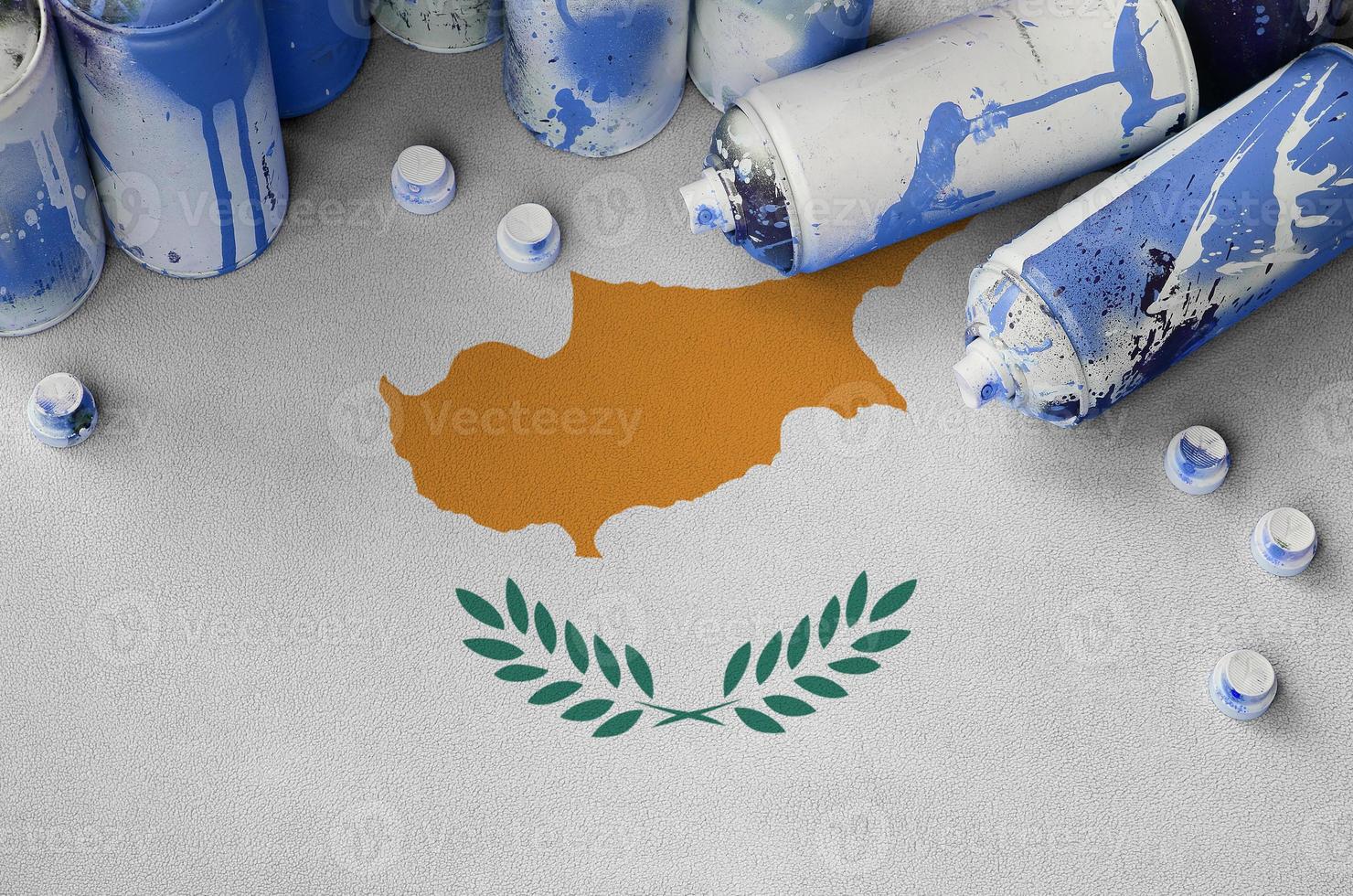 Cyprus flag and few used aerosol spray cans for graffiti painting. Street art culture concept photo