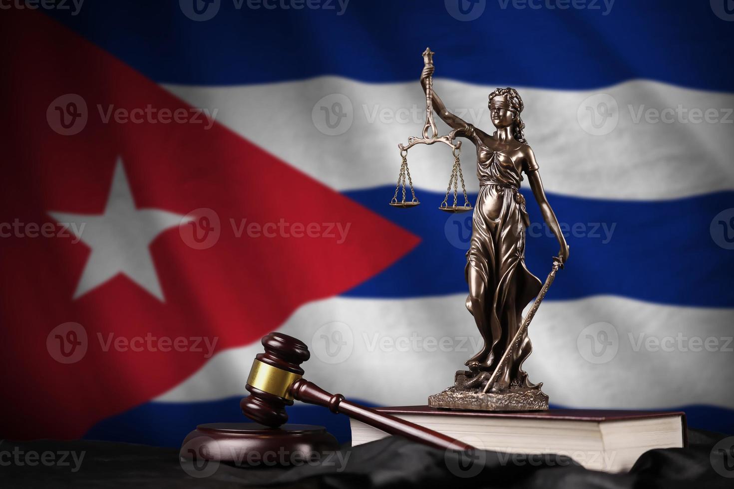 Cuba flag with statue of lady justice, constitution and judge hammer on black drapery. Concept of judgement and guilt photo