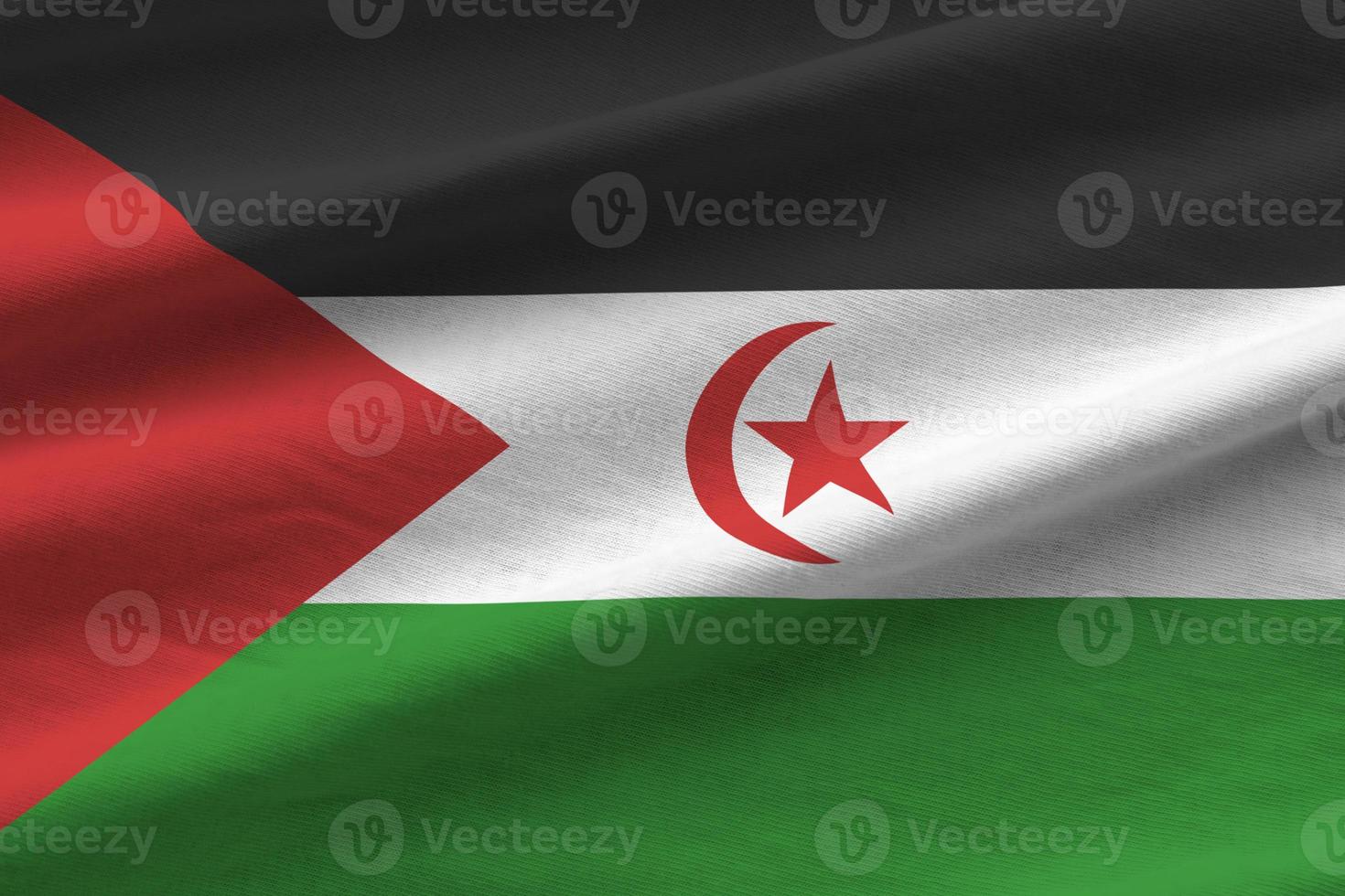 Western Sahara flag with big folds waving close up under the studio light indoors. The official symbols and colors in banner photo