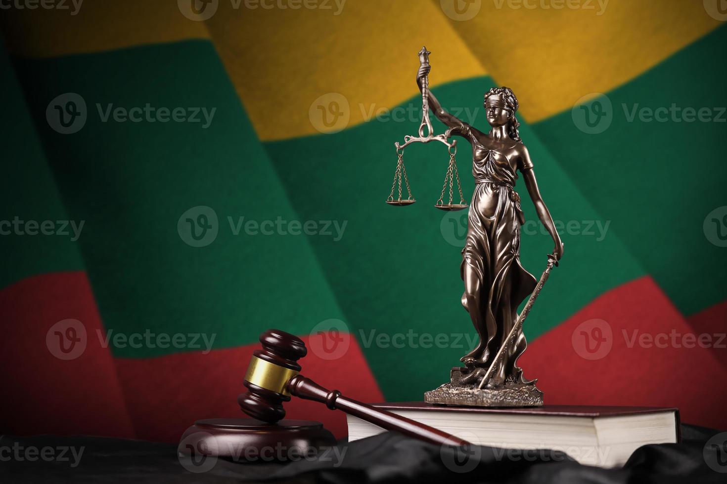 Lithuania flag with statue of lady justice, constitution and judge hammer on black drapery. Concept of judgement and guilt photo