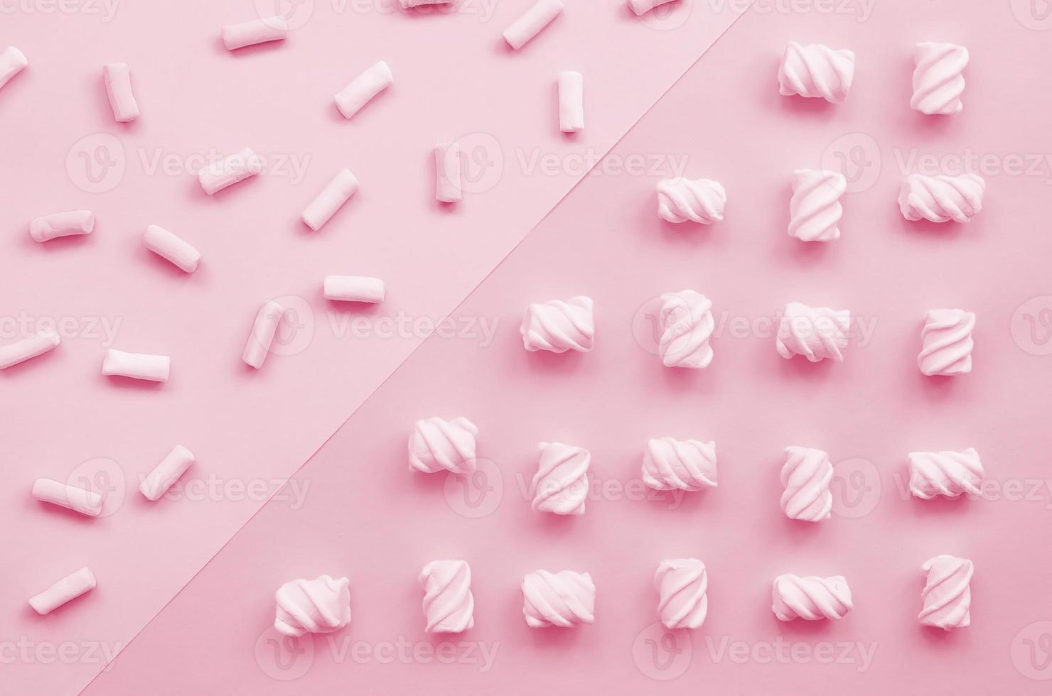 Colorful marshmallow laid out on violet and blue paper background. pastel creative textured pattern. minimal Image toned in Viva Magenta, color of the 2023 year photo