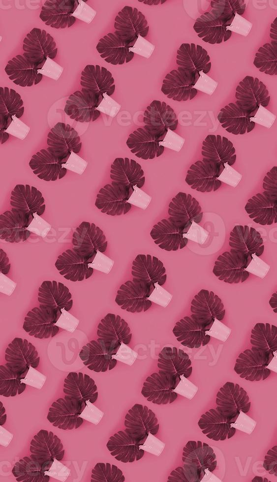 Tropical palm monstera leaves lies in a pastel pails on a ed background. Flat lay trendy minimal pattern. Image toned in Viva Magenta, color of the 2023 year photo