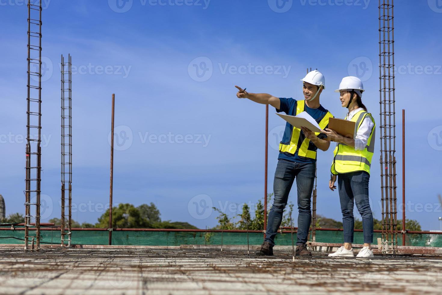 Team of engineering architect inspector and contractor having discussion while examining the quality of construction work of real estate development project concept photo