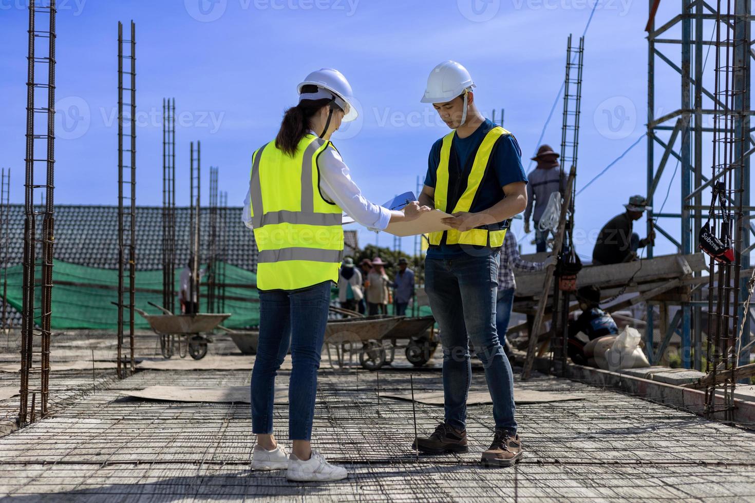 Team of engineering architect inspector and contractor having discussion while examining the quality of construction work of real estate development project concept photo