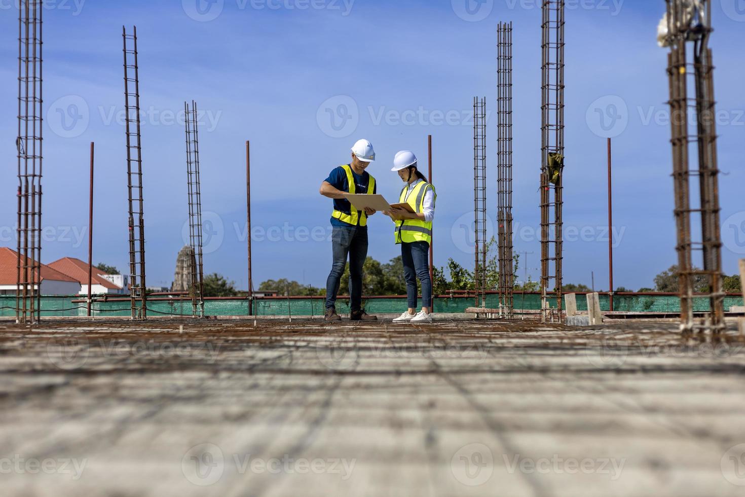 Team of engineering architect inspector and contractor having discussion while examining the quality of construction work of real estate development project concept photo