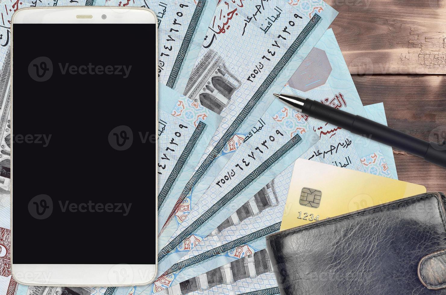 5 Egyptian pounds bills and smartphone with purse and credit card. E-payments or e-commerce concept. Online shopping and business with portable devices photo