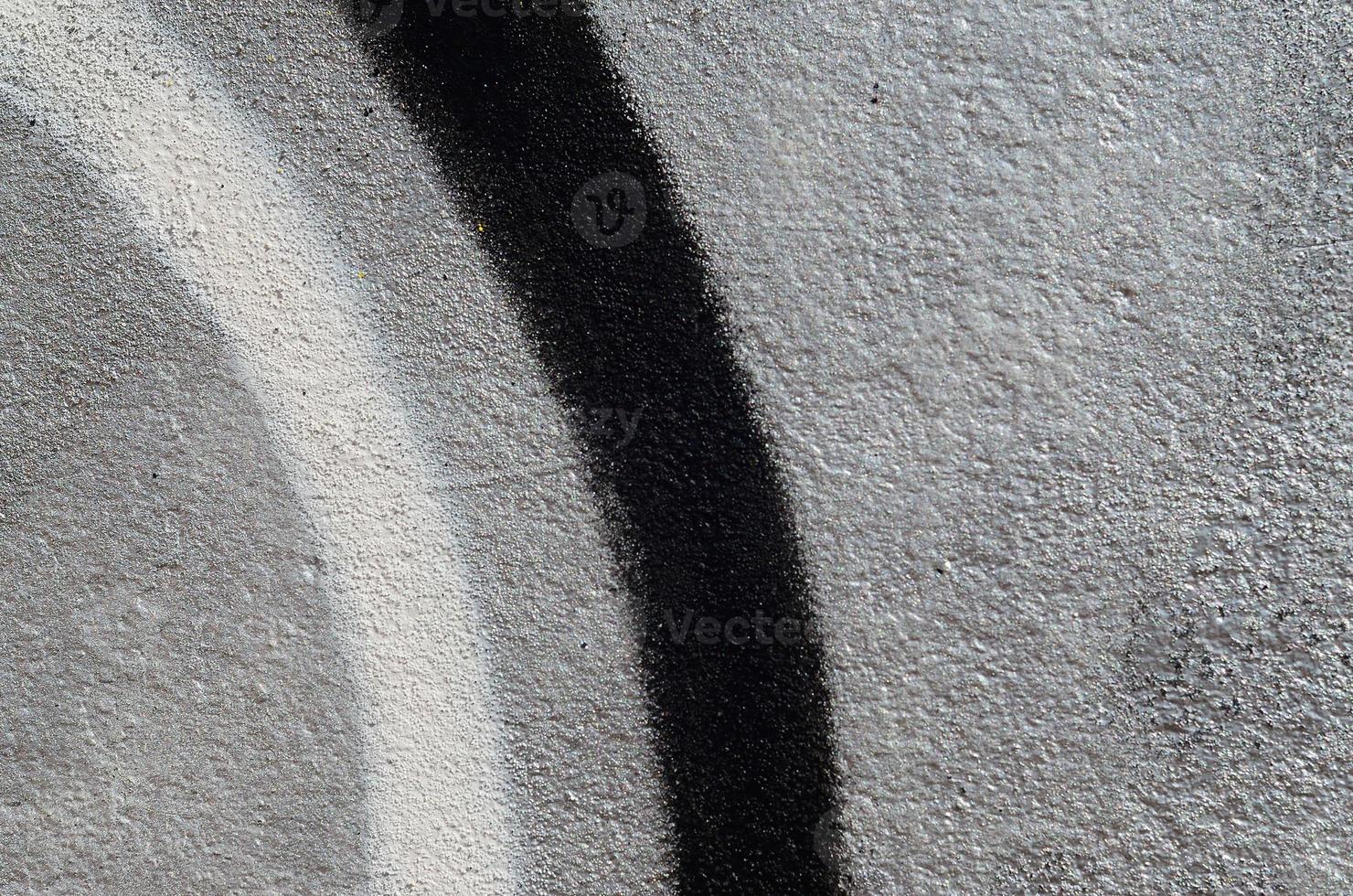 Fragment of graffiti drawings. The old wall decorated with paint stains in the style of street art culture. Colored background texture photo