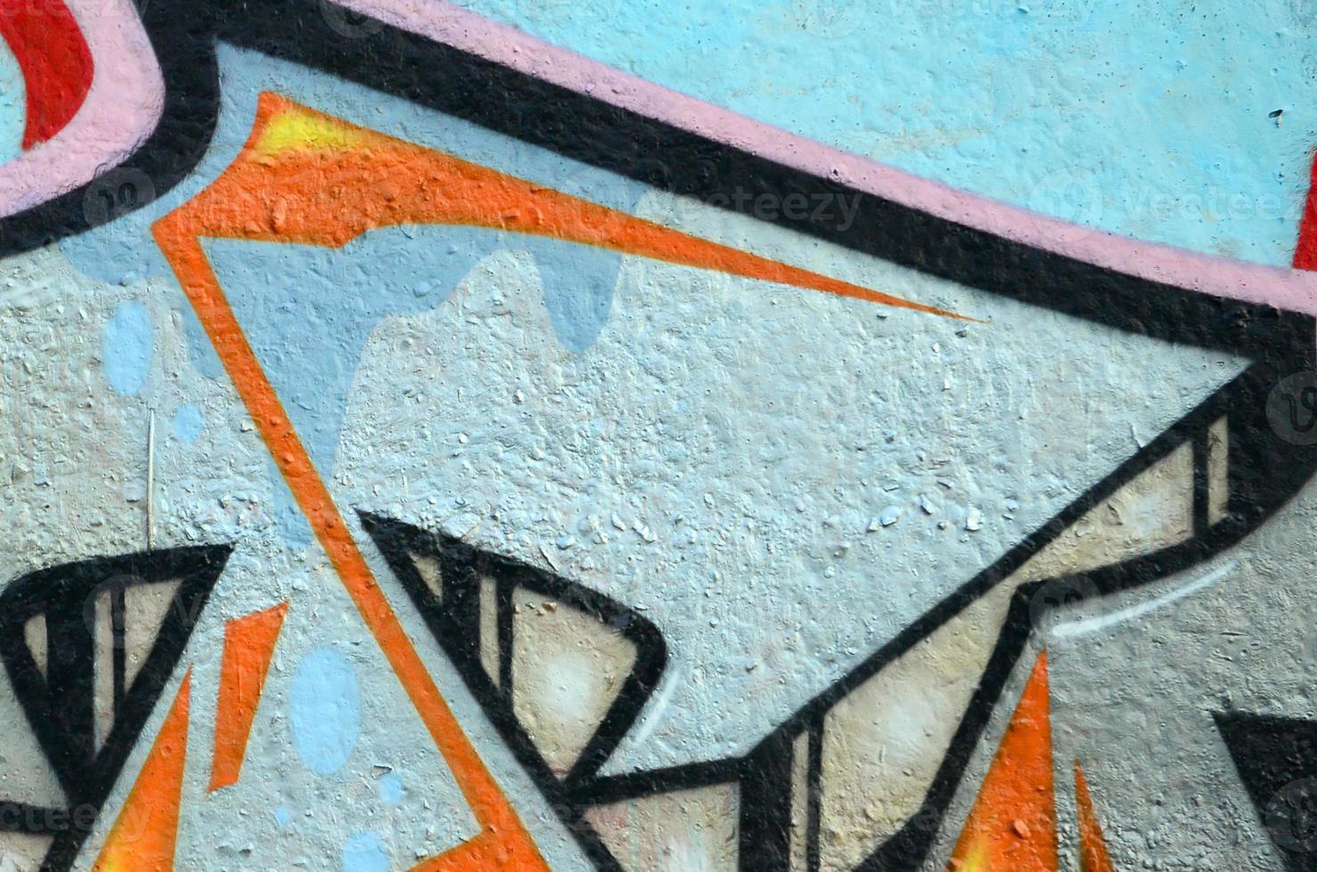 Fragment of graffiti drawings. The old wall decorated with paint stains in the style of street art culture. Colored background texture photo