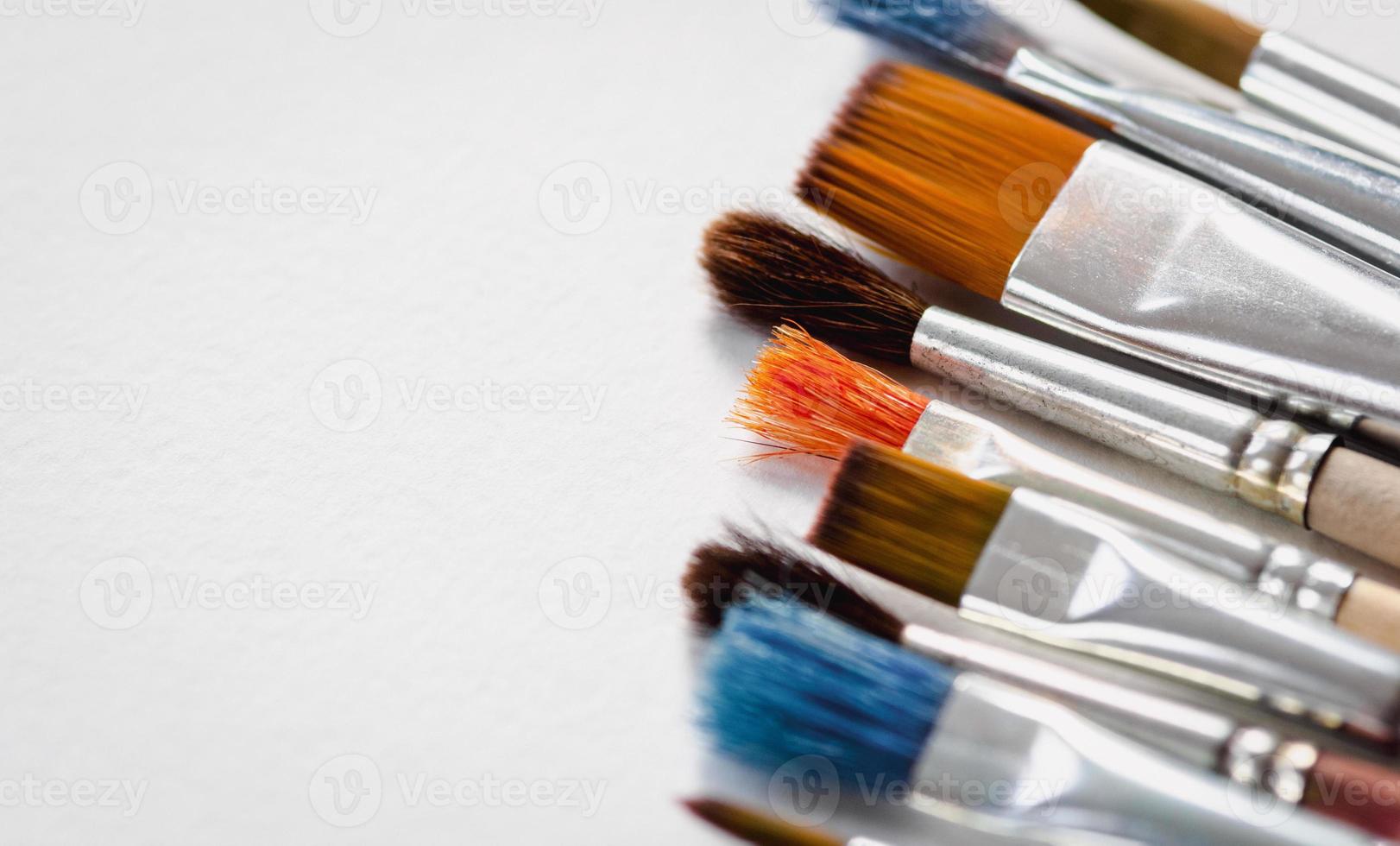 Art brushes on white background, paintbrushes on blank paper copy space photo