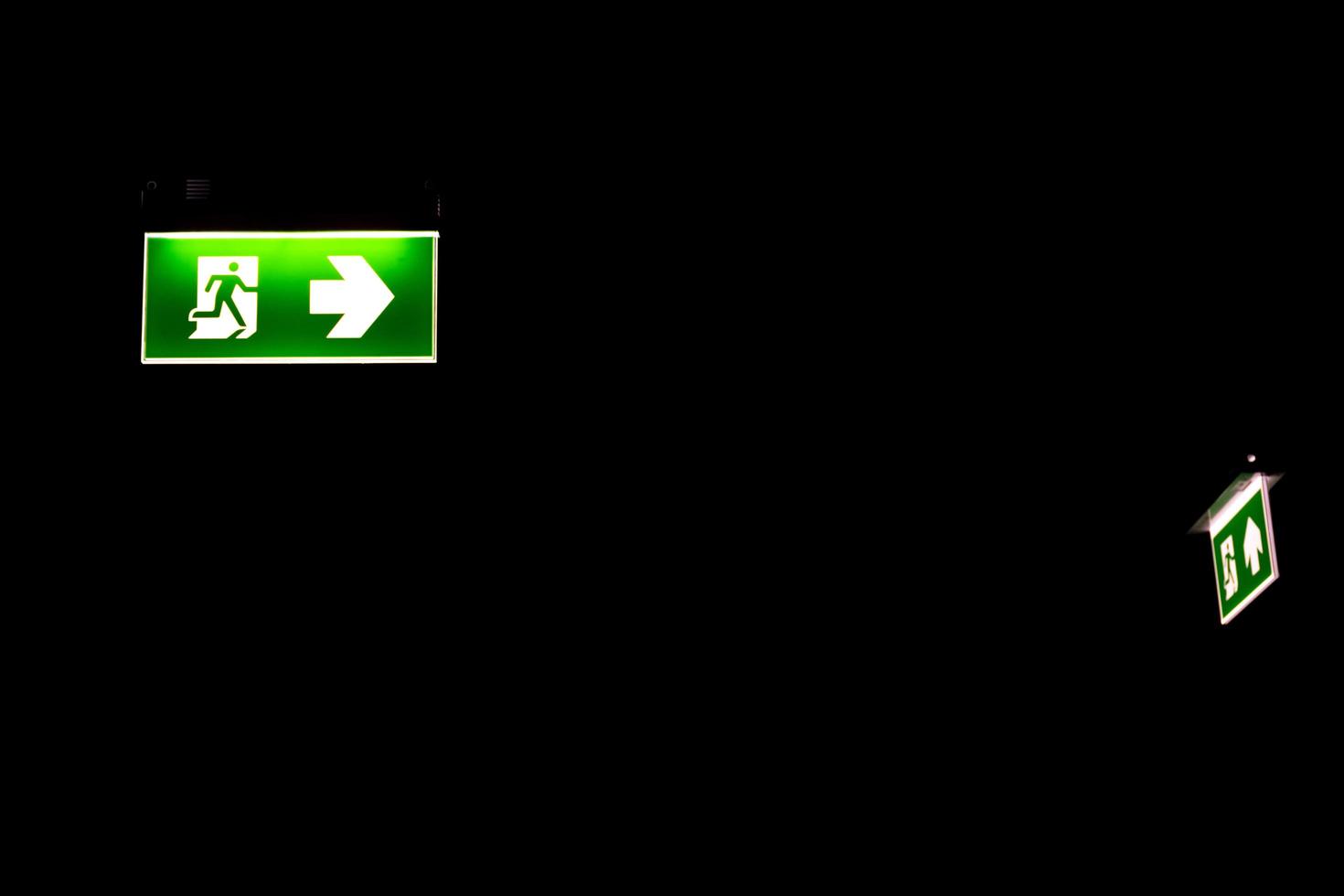 Green emergency exit sing in darkness photo