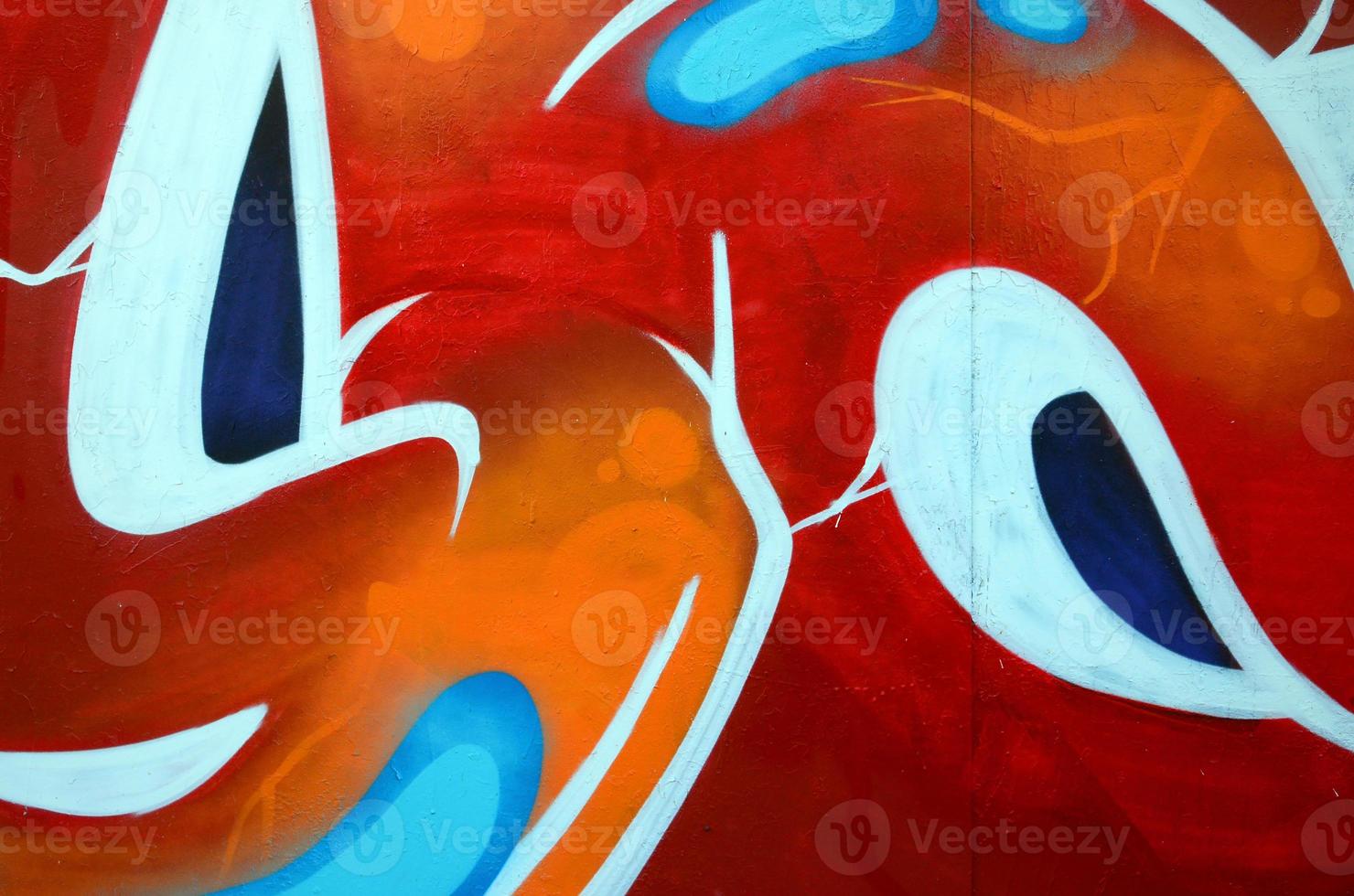 Fragment of graffiti drawings. The old wall decorated with paint stains in the style of street art culture. Colored background texture photo