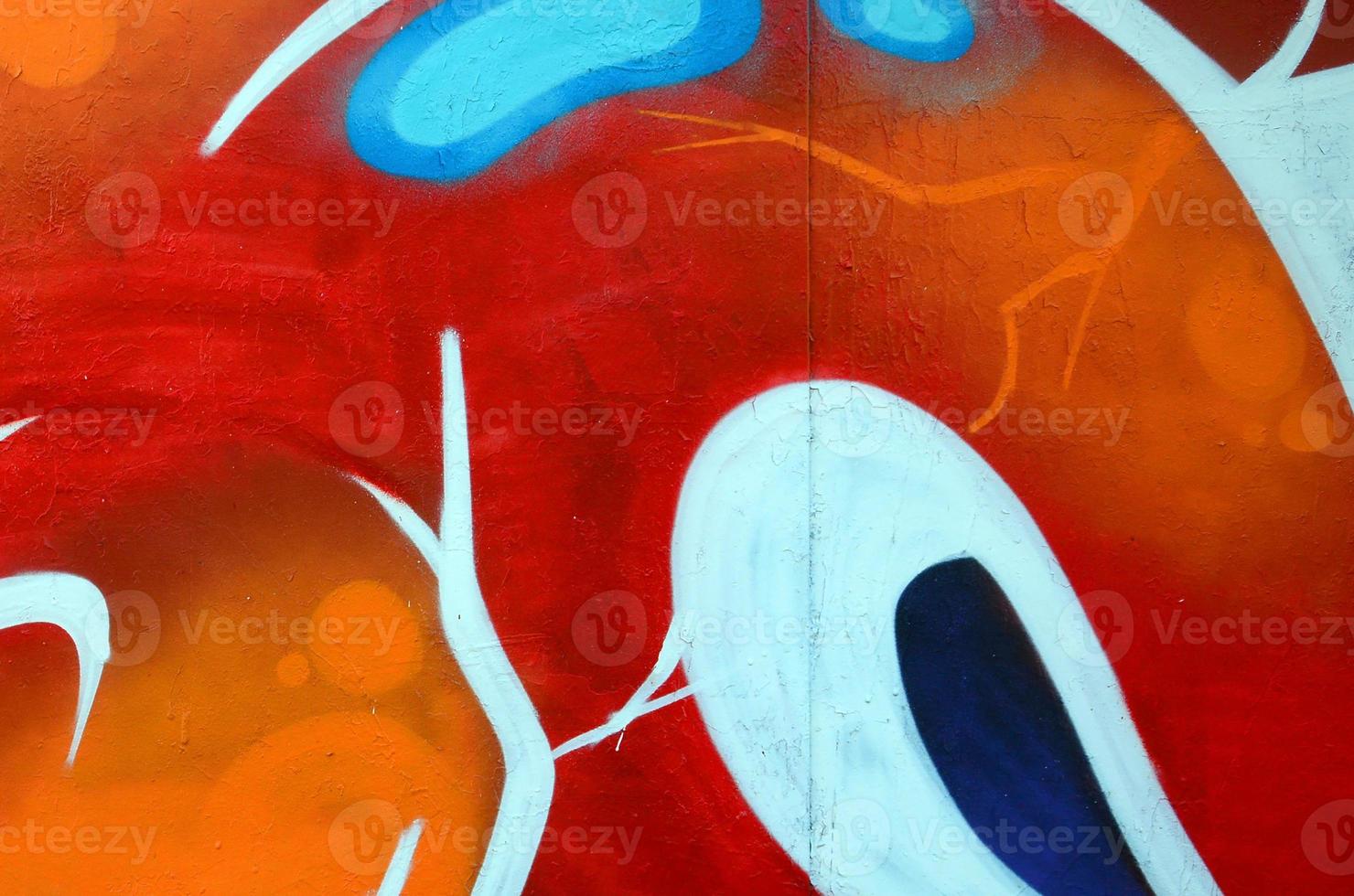 Fragment of graffiti drawings. The old wall decorated with paint stains in the style of street art culture. Colored background texture photo
