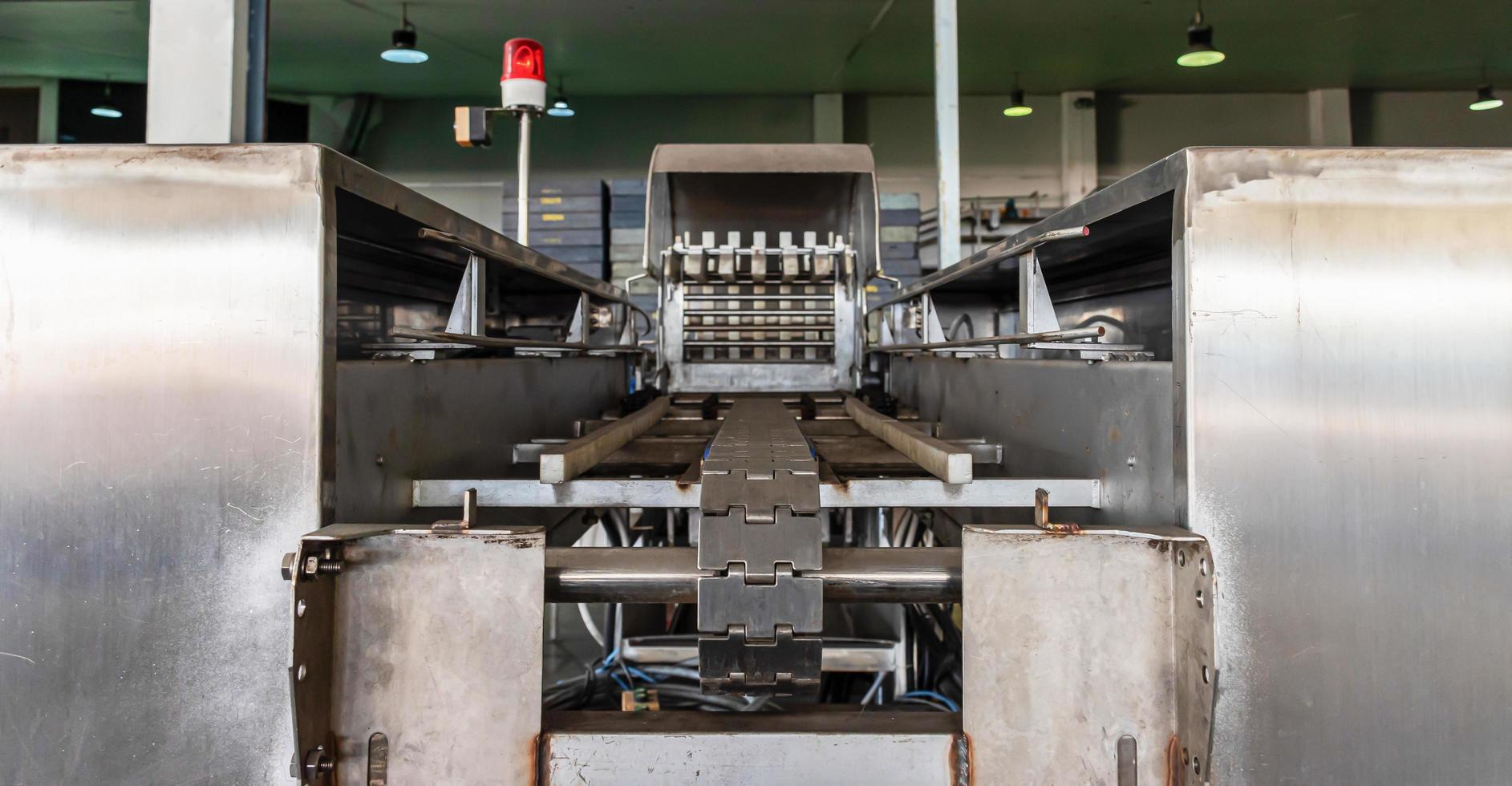 Conveyor belt in to crate washing machine in production line photo