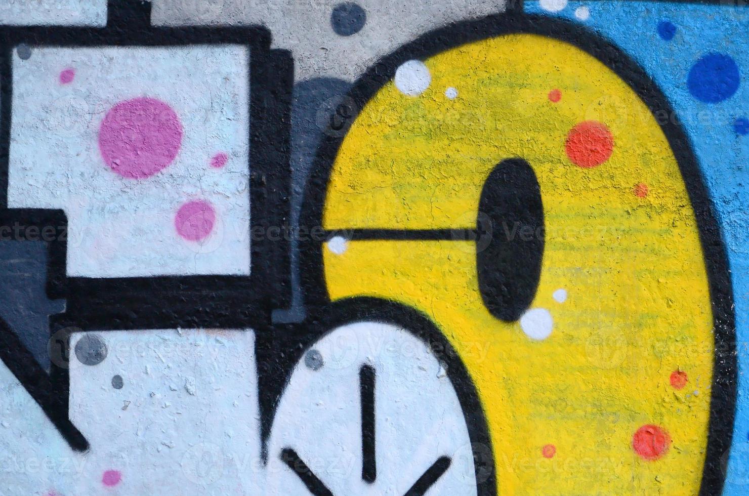 Fragment of graffiti drawings. The old wall decorated with paint stains in the style of street art culture. Colored background texture photo