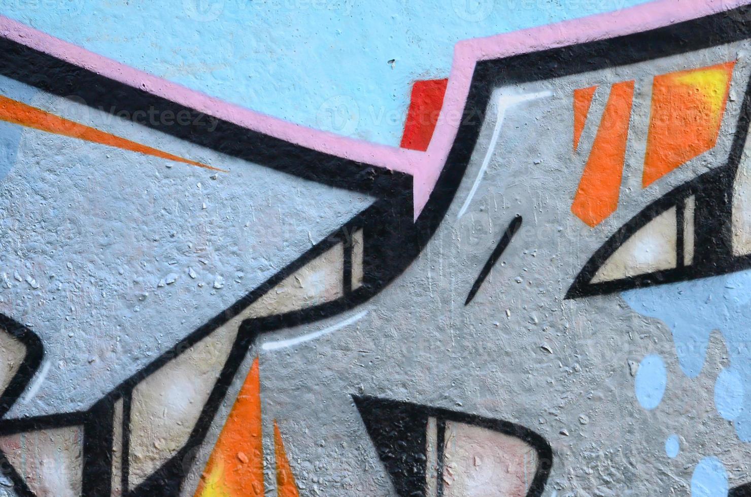Fragment of graffiti drawings. The old wall decorated with paint stains in the style of street art culture. Colored background texture photo