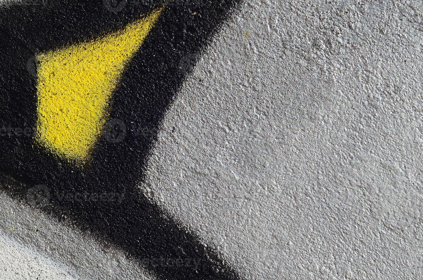 Fragment of graffiti drawings. The old wall decorated with paint stains in the style of street art culture. Colored background texture photo
