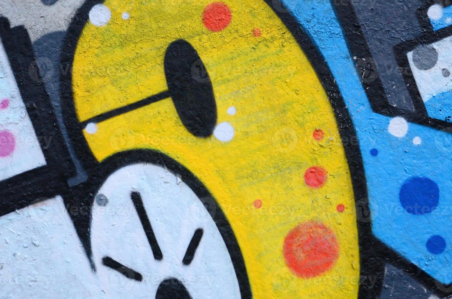 Fragment of graffiti drawings. The old wall decorated with paint stains in the style of street art culture. Colored background texture photo