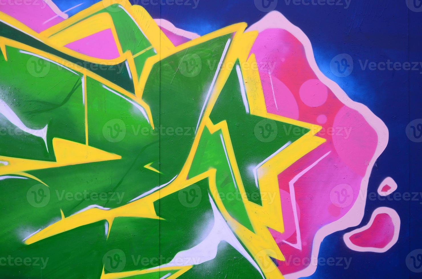 Fragment of graffiti drawings. The old wall decorated with paint stains in the style of street art culture. Colored background texture photo