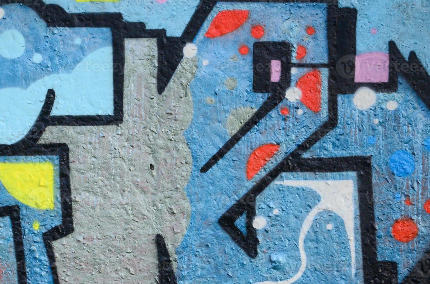 Fragment of graffiti drawings. The old wall decorated with paint stains in the style of street art culture. Colored background texture photo