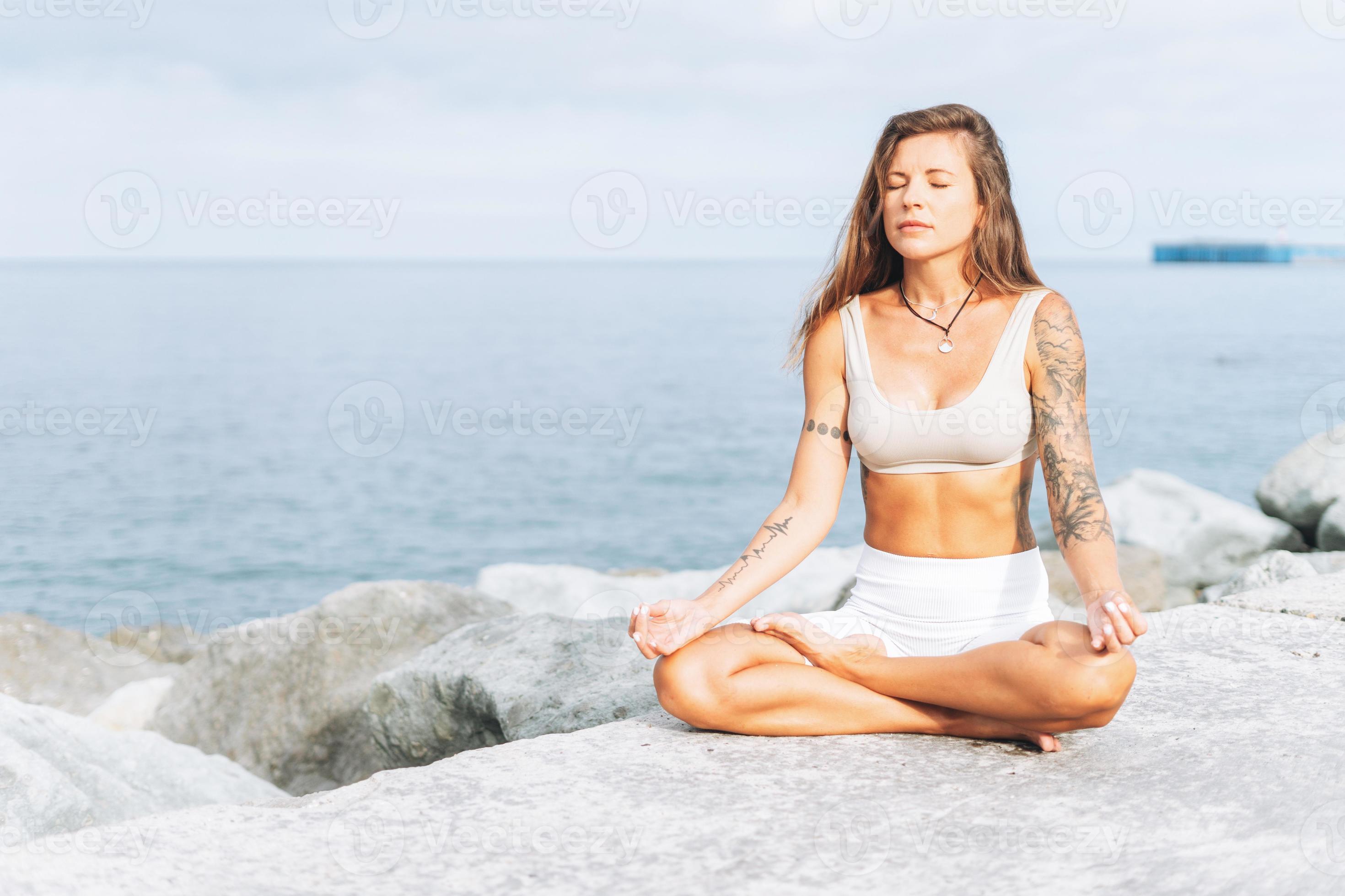 Beautiful young atlethic woman wearing sportswear doing yoga