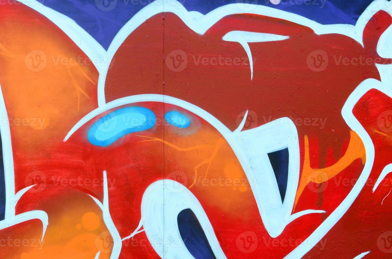 Fragment of graffiti drawings. The old wall decorated with paint stains in the style of street art culture. Colored background texture photo