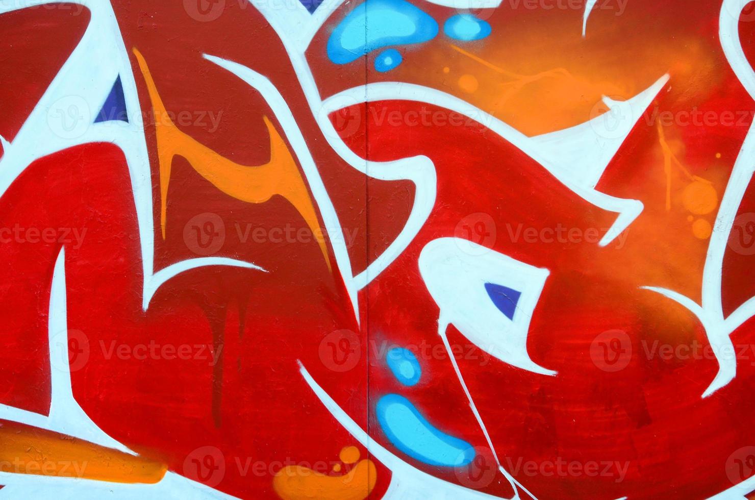 Fragment of graffiti drawings. The old wall decorated with paint stains in the style of street art culture. Colored background texture photo