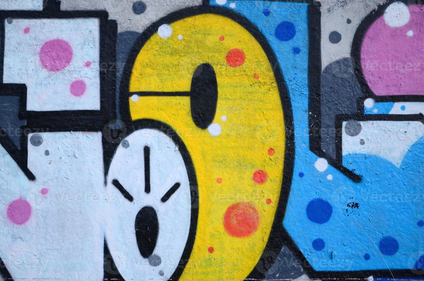 Fragment of graffiti drawings. The old wall decorated with paint stains in the style of street art culture. Colored background texture photo