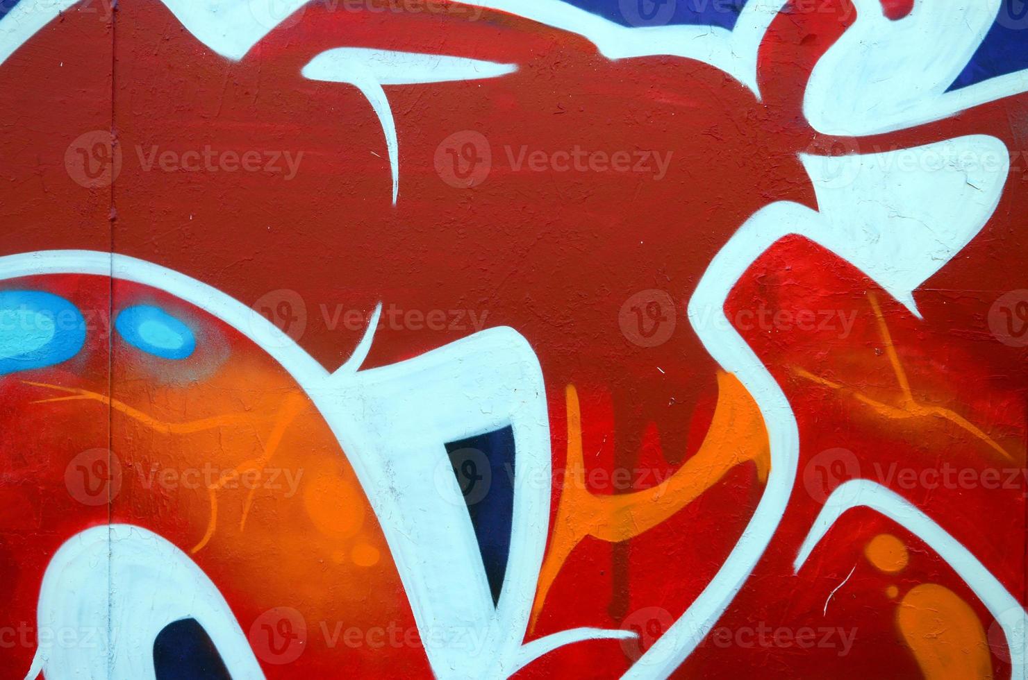 Fragment of graffiti drawings. The old wall decorated with paint stains in the style of street art culture. Colored background texture photo
