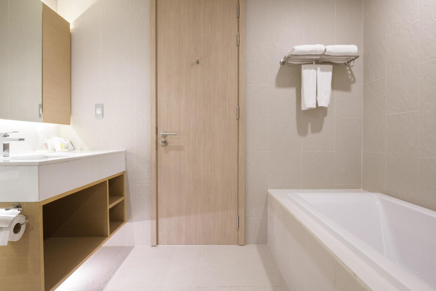 Loft white tile bathroom corner, tub and sink photo