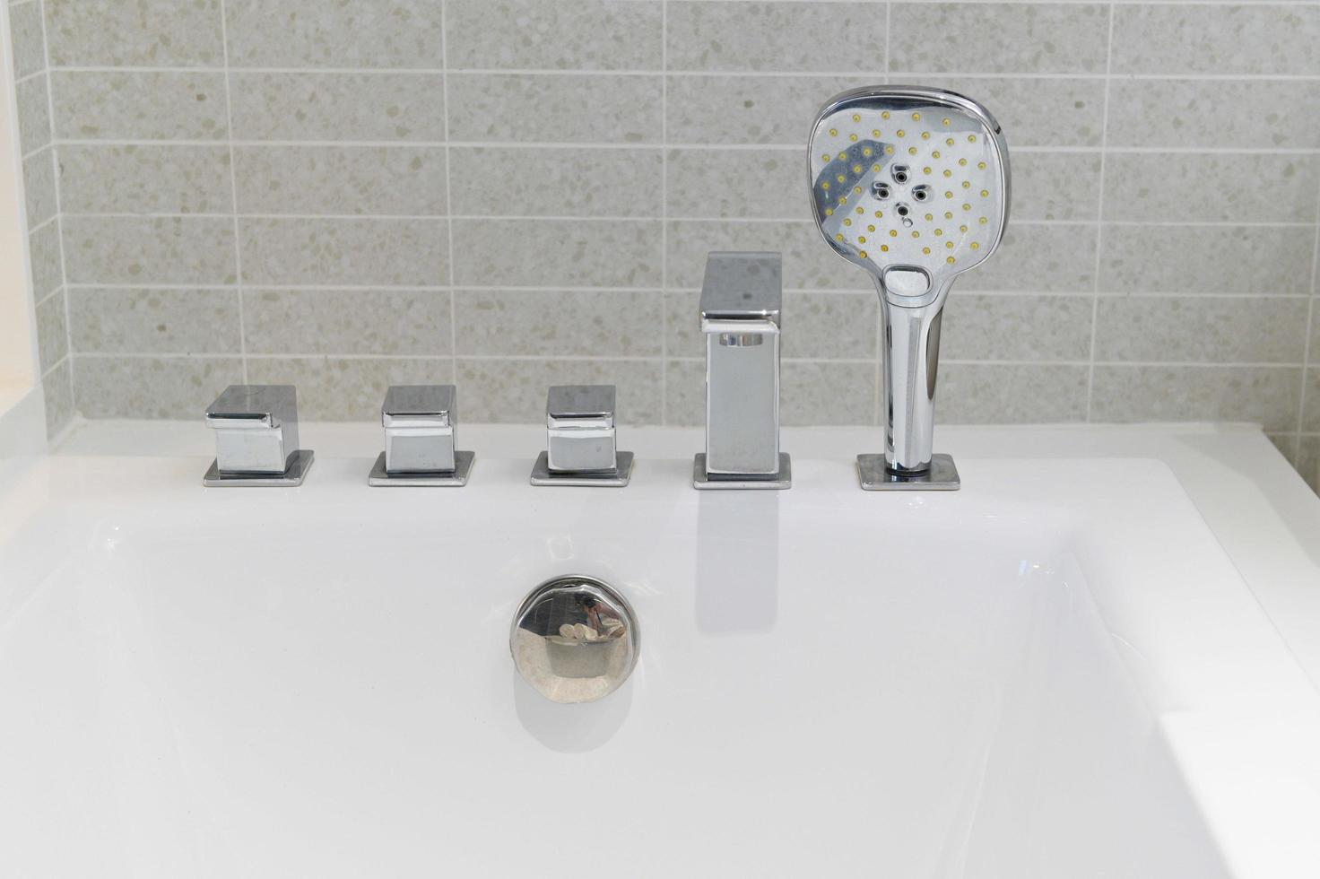 shower head and faucet bathtube in white bathroom photo