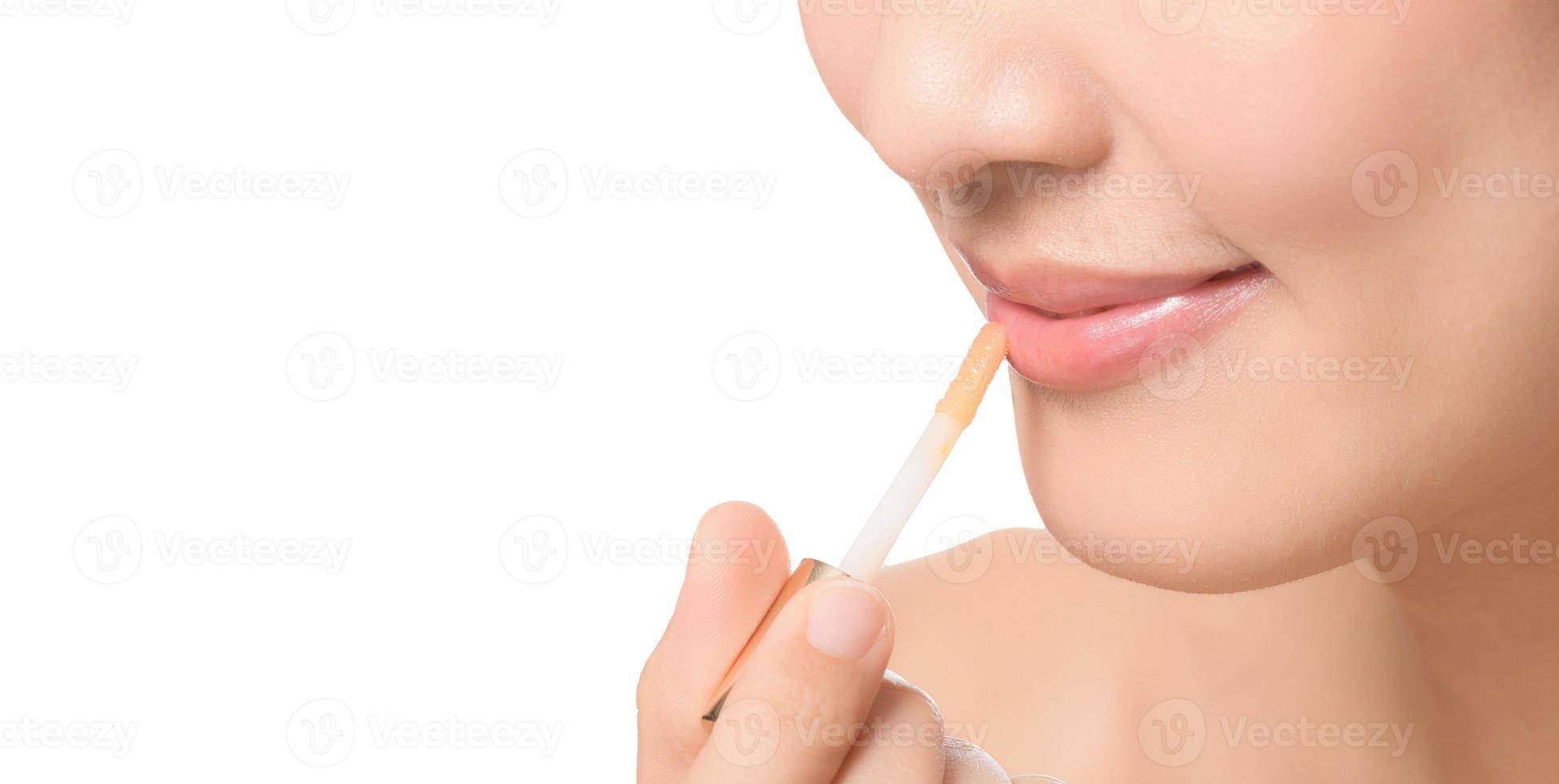 Beautiful portrait young asian woman looking mirror applying makeup lipstick at room. clipping path photo