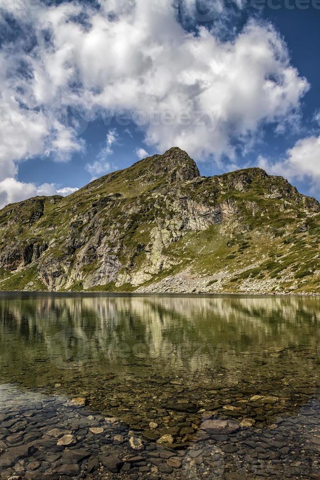 Beauty landscape reflection of mountain hills in the lake, Rila mountain, Bulgaria photo