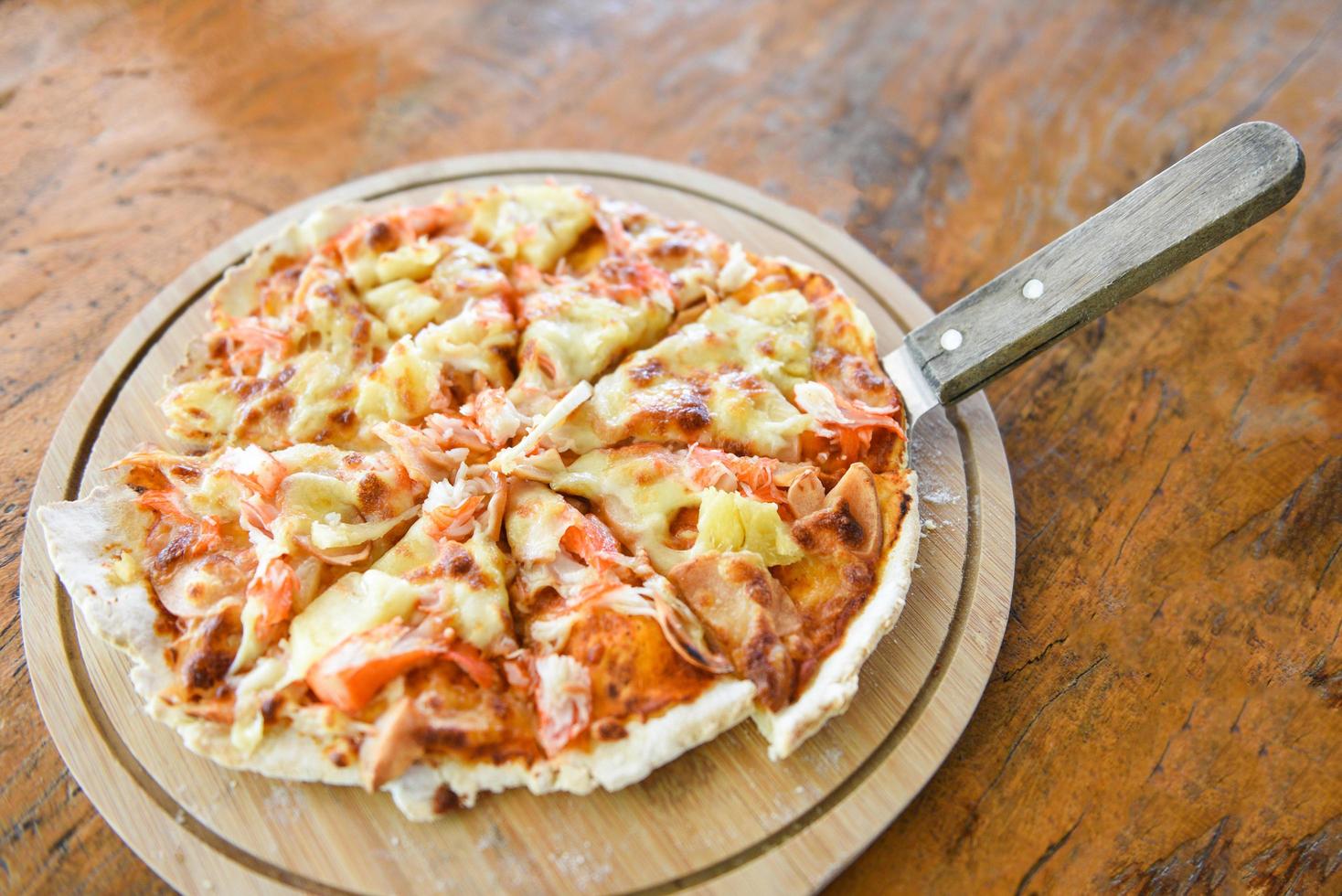 Pizza cheese slice on wooden tray and served on a wooden table , top view Homemade pastry pizza Italian is cooked traditional food photo