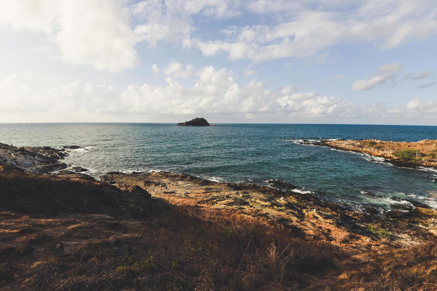 View of sea waves and fantastic rocky coast landscape - Seascape rock tropical island with ocean and blue sky background in Thailand photo