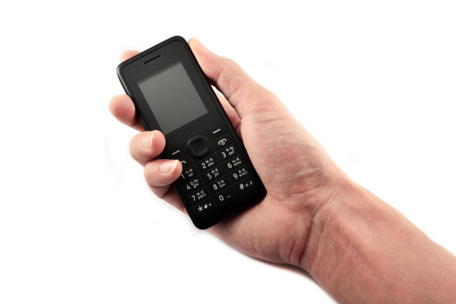 Telephone in hand Old model mobile phone isolated on white background photo