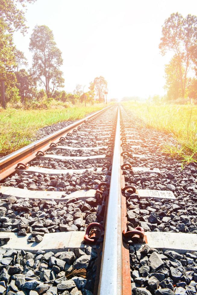 Railway - railroad tracks steel for trains in countryside on nature summer background photo