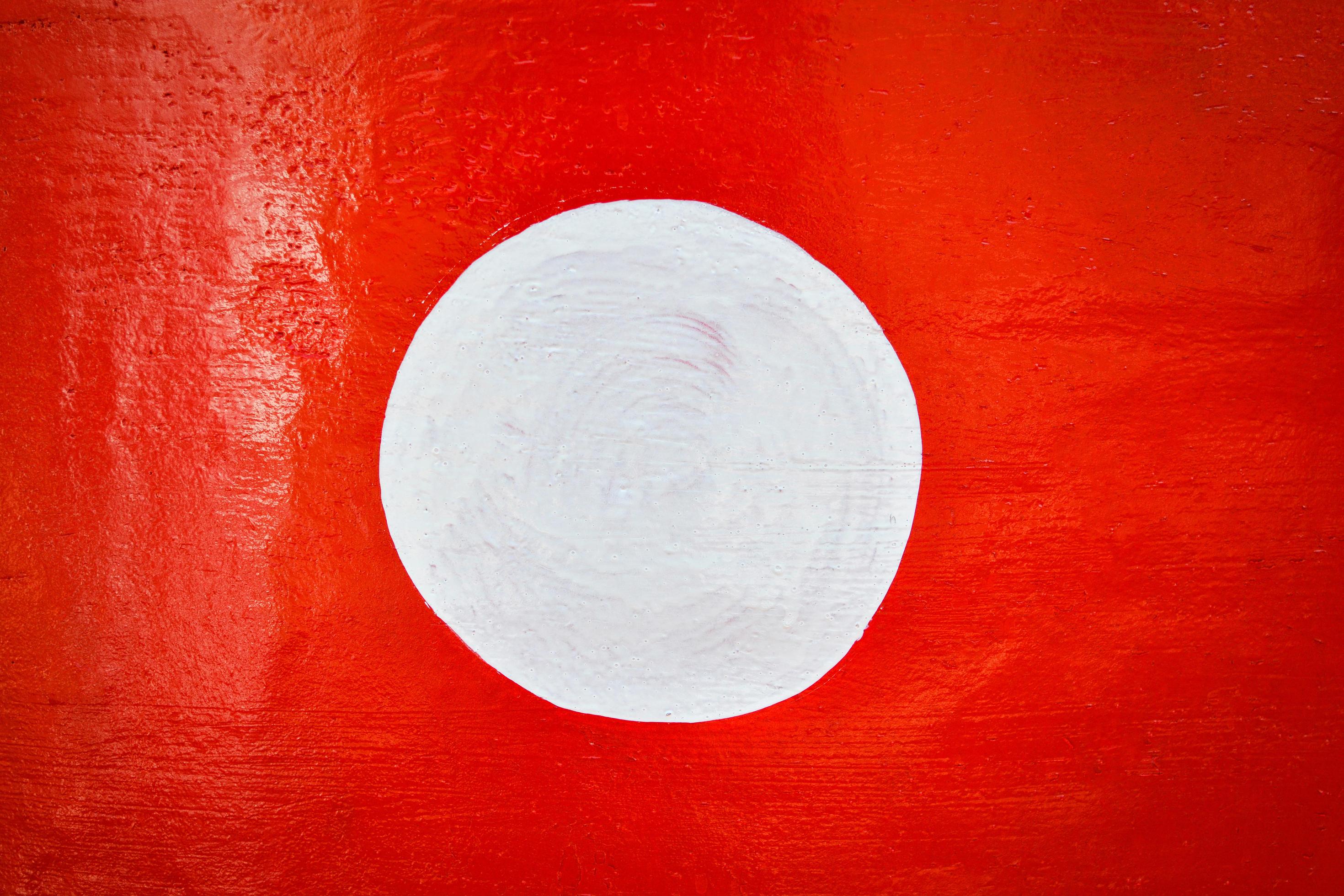 Red background and white circle on center paint on red wall 17024413