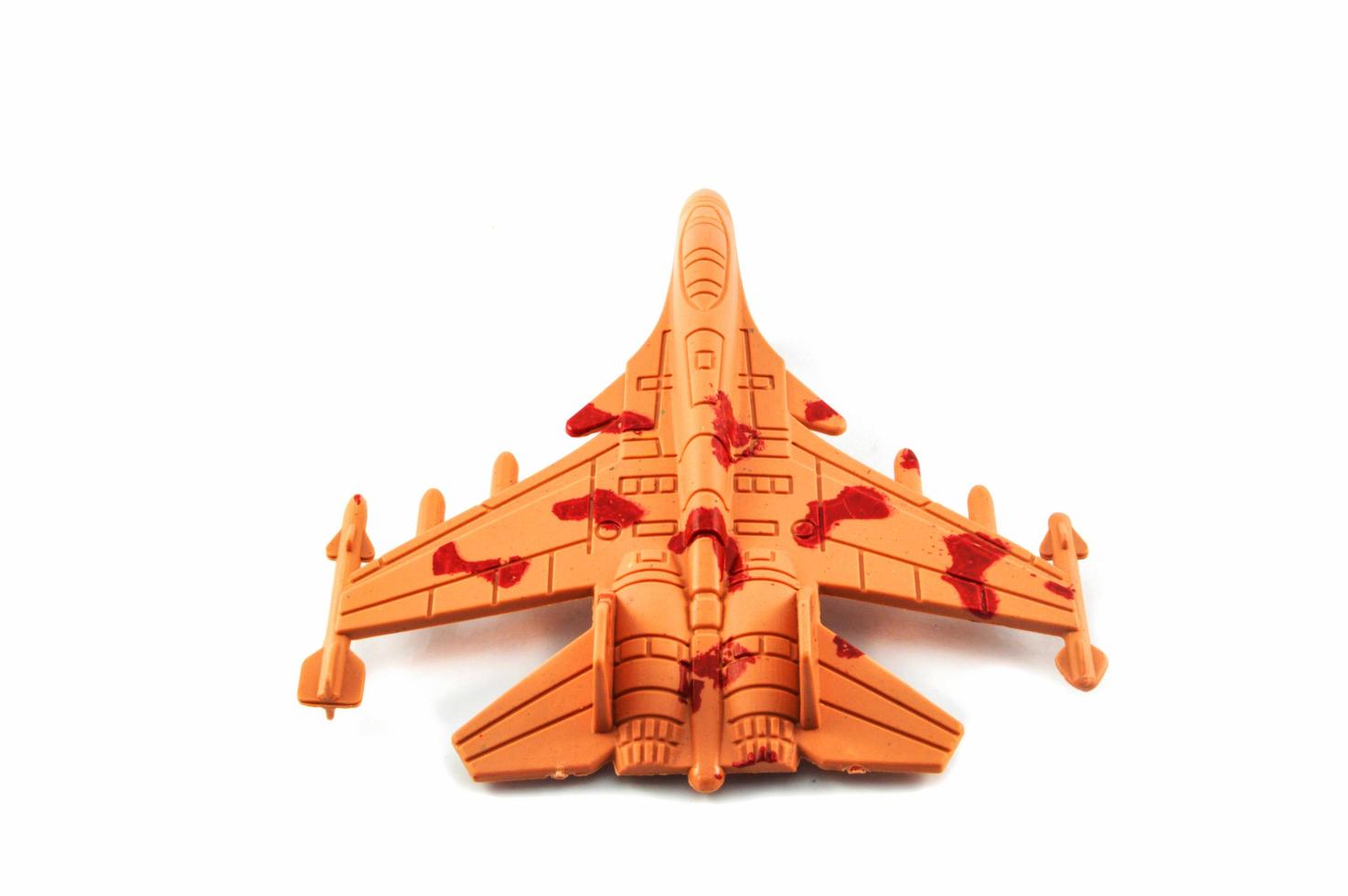 juguete de combate de aviones a reacción aislado sobre fondo blanco avión de juguete militar camuflaje naranja foto