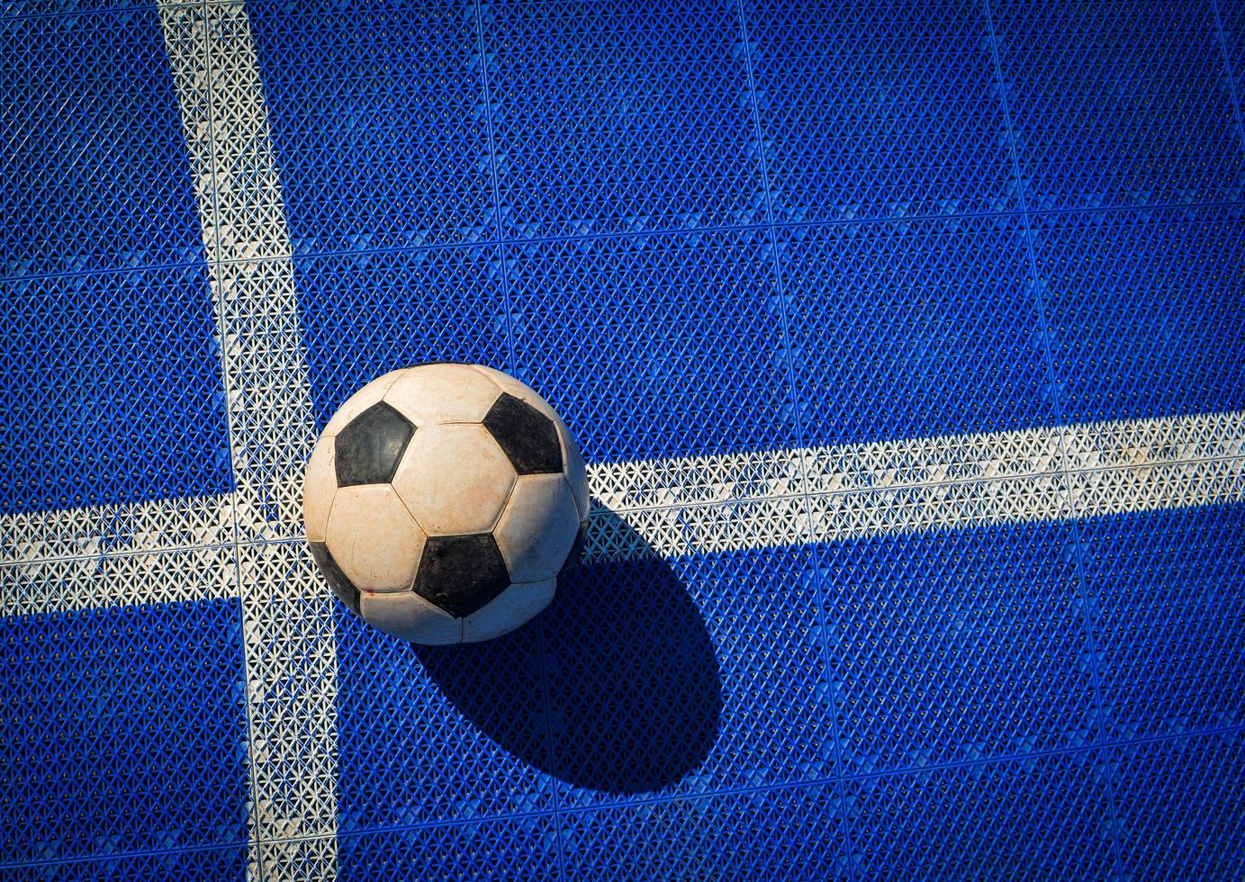 Soccer football on futsal field blue and white line at sport outdoor photo