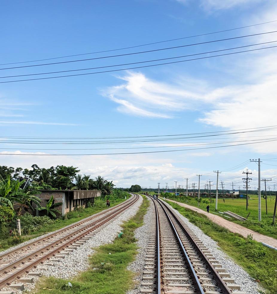 Railway in the rural area of Bangladesh. Empty railroad with fresh afternoon view. photo