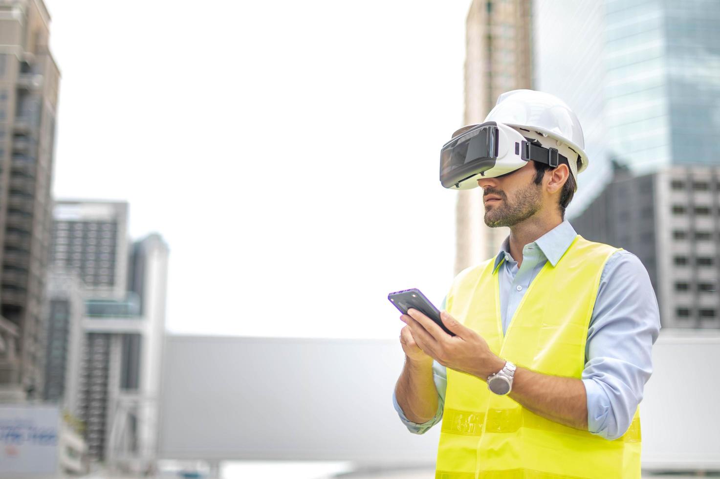 Caucasian man use VR glasses watching video for entertainment, work, free time and study, while hand holding a smartphone for control the VR glasses. photo