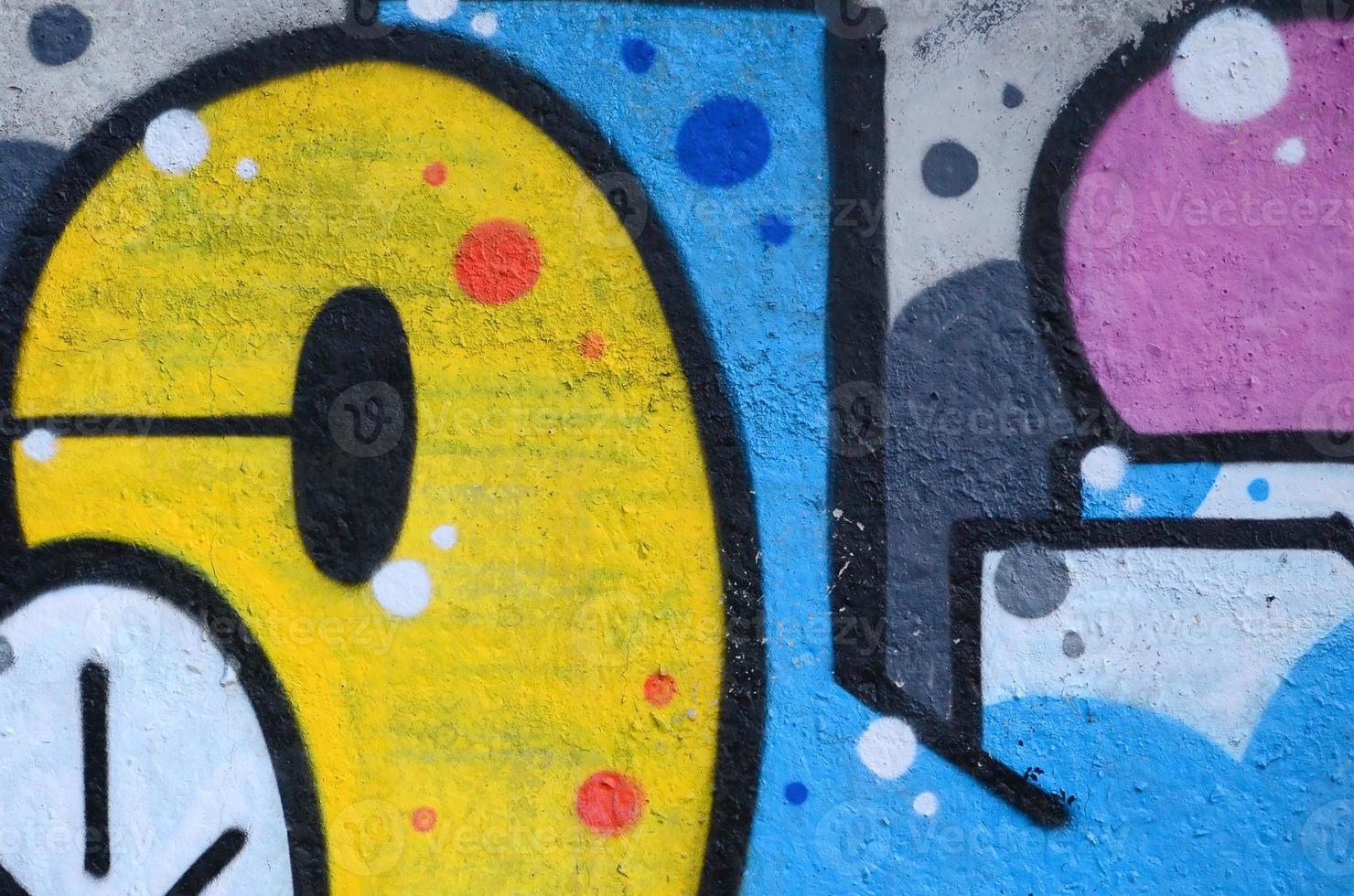 Fragment of graffiti drawings. The old wall decorated with paint stains in the style of street art culture. Colored background texture photo