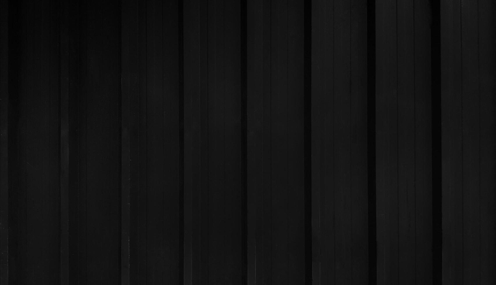 Black stainless steel background in vintage tone. Dark shutter door wall with copy space. Line pattern of curtain or zinc wallpaper concept. photo