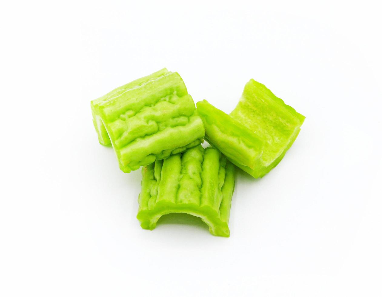 Fresh Chinese bitter gourd or bitter cucumber slice isolated on white background. Organic vegetable, Good for healthy and Harvest of agriculture. Sliced or cut into pieces for cooking food. photo