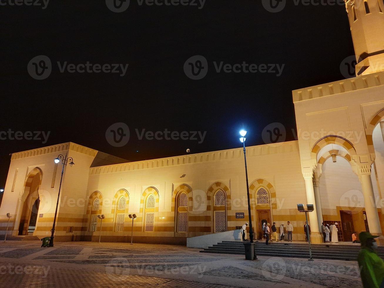 A beautiful night view of the Sayed Al Shuhada Mosque in Madinah, Saudi Arabia photo