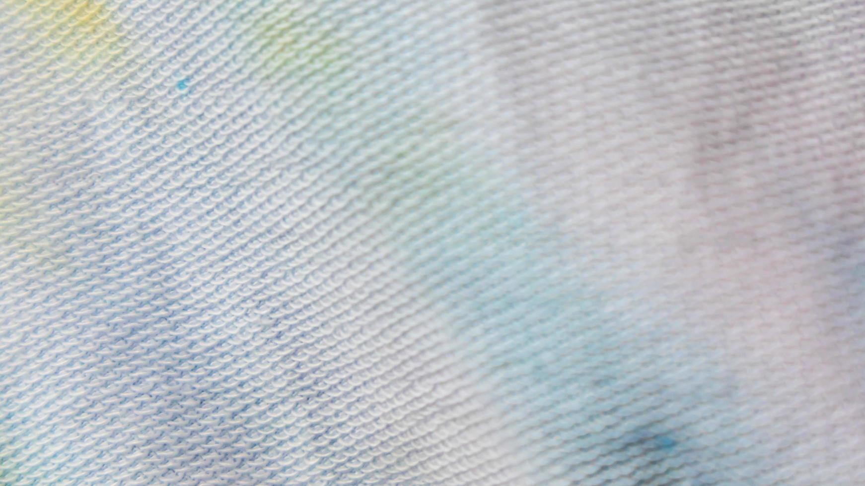 white cloth texture with yellow and blue patterns as background photo