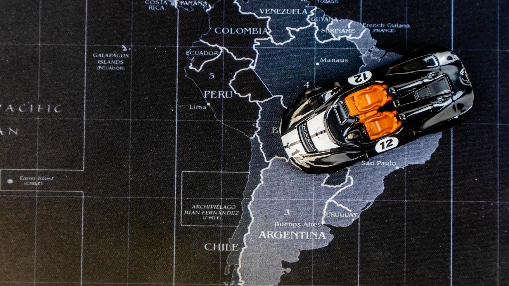 Minahasa, Indonesia  December 2022, toy car is black over the map photo