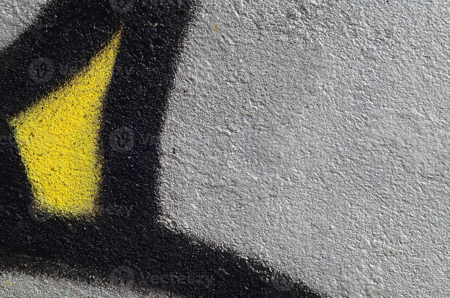 Fragment of graffiti drawings. The old wall decorated with paint stains in the style of street art culture. Colored background texture photo