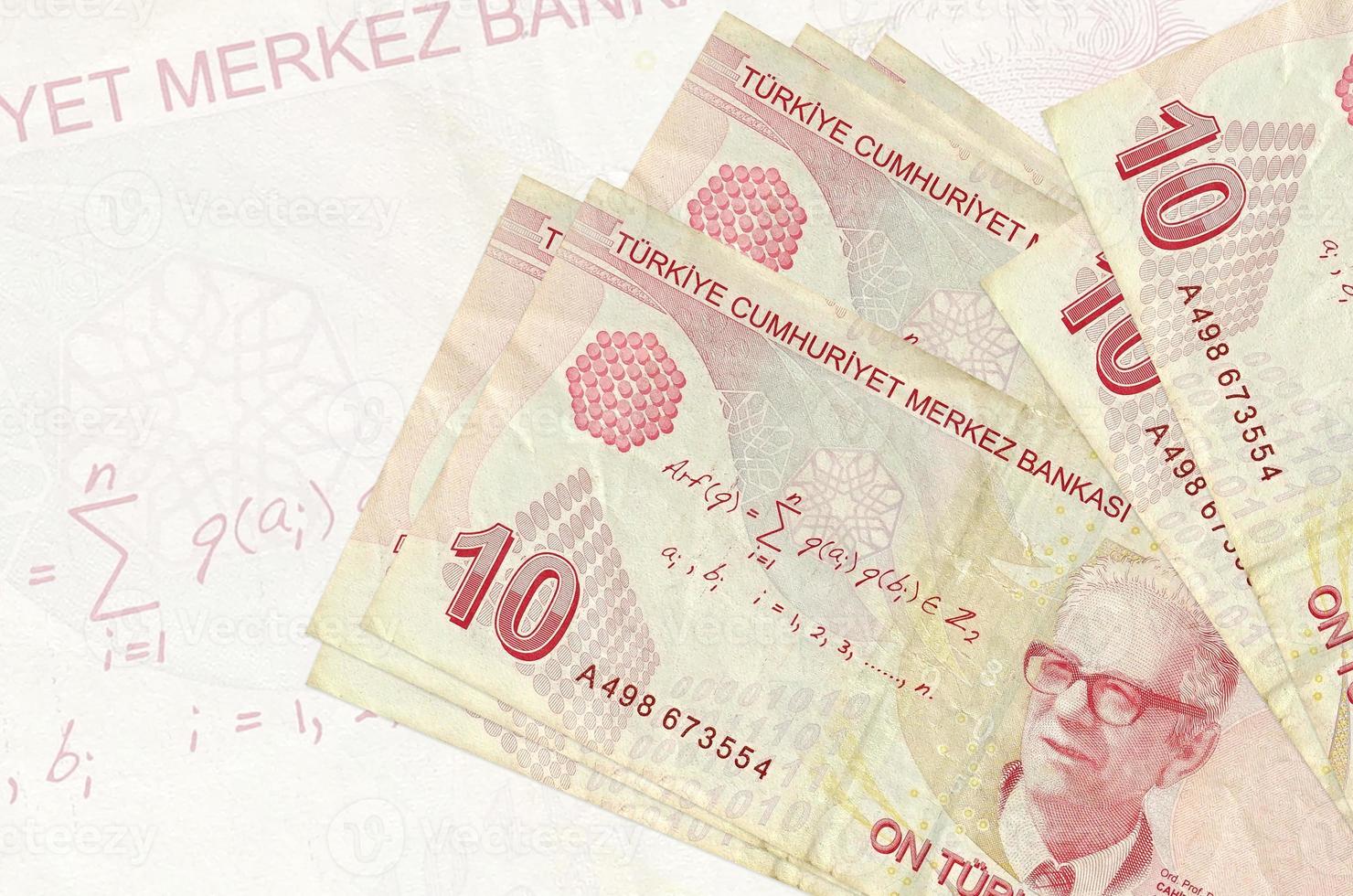 10 Turkish liras bills lies in stack on background of big semi-transparent banknote. Abstract presentation of national currency photo