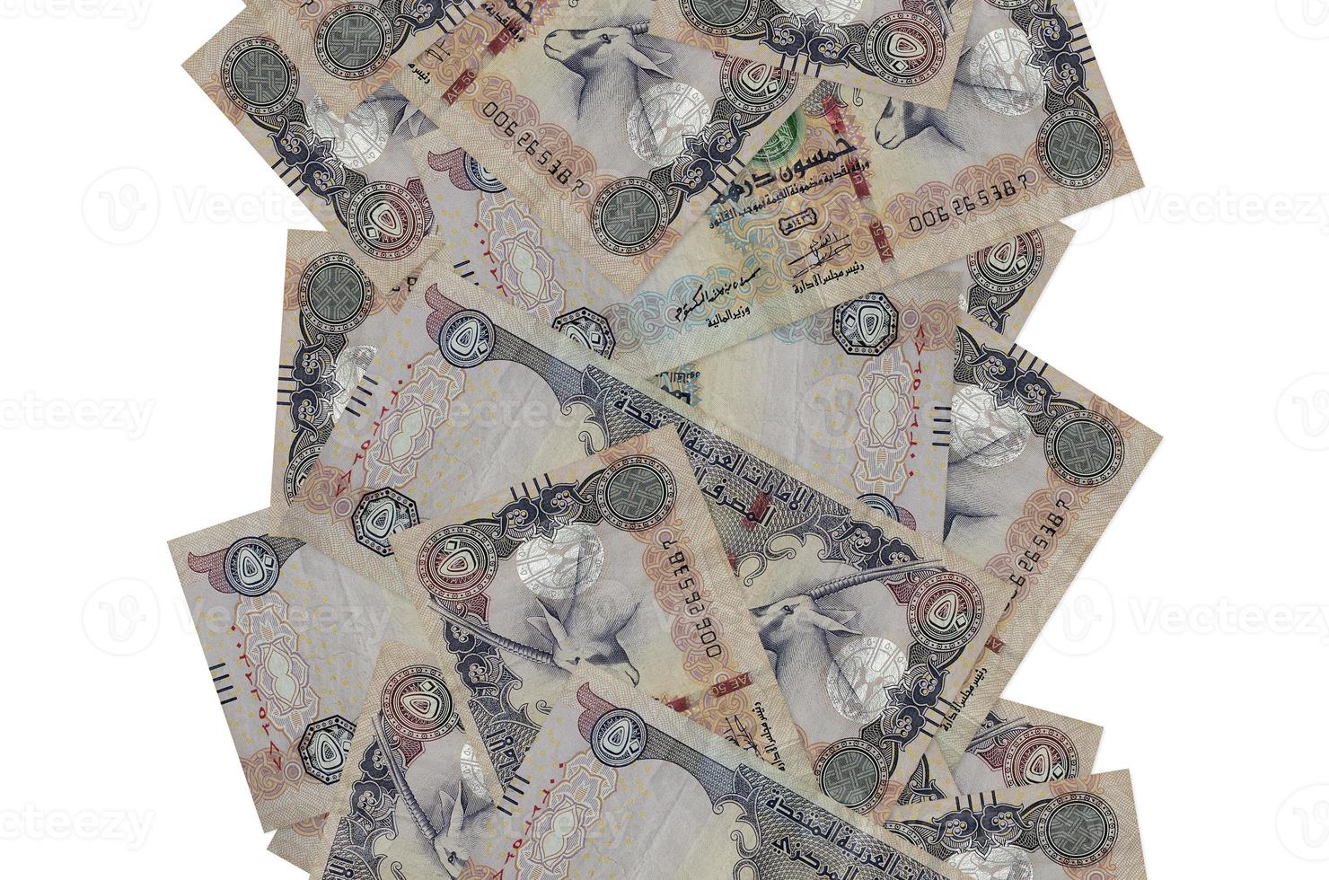 50 UAE dirhams bills flying down isolated on white. Many banknotes falling with white copyspace on left and right side photo